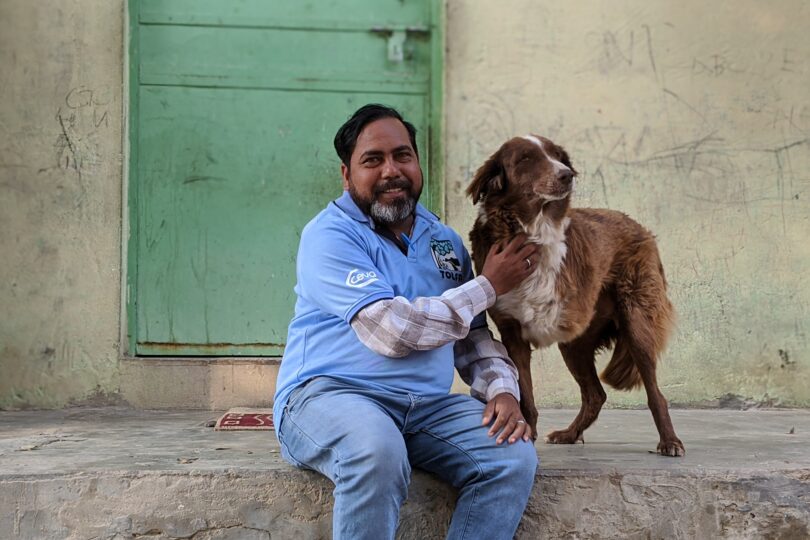 Team member Sitaram with three legged dog