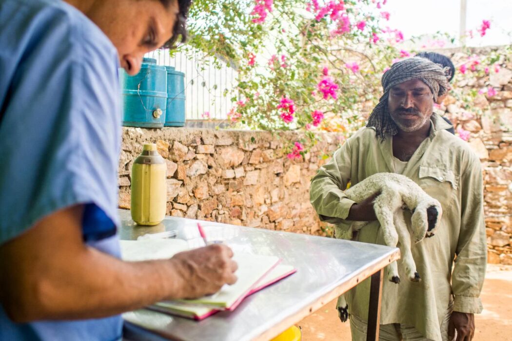 Farmer at the dispensary with a kid goat