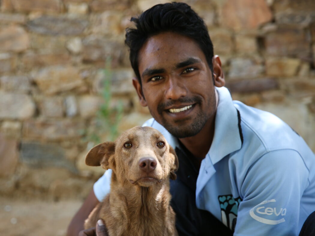 A team member with a CEVA logo t-shirt and a brown dog